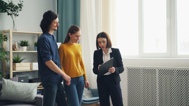 a-landlord-showing-tenants-information-on-a-clipboard