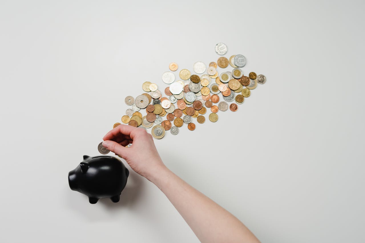 coin being put in blue piggy bank