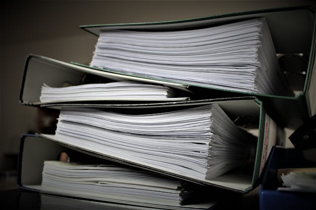 a stack of binders filled with papers